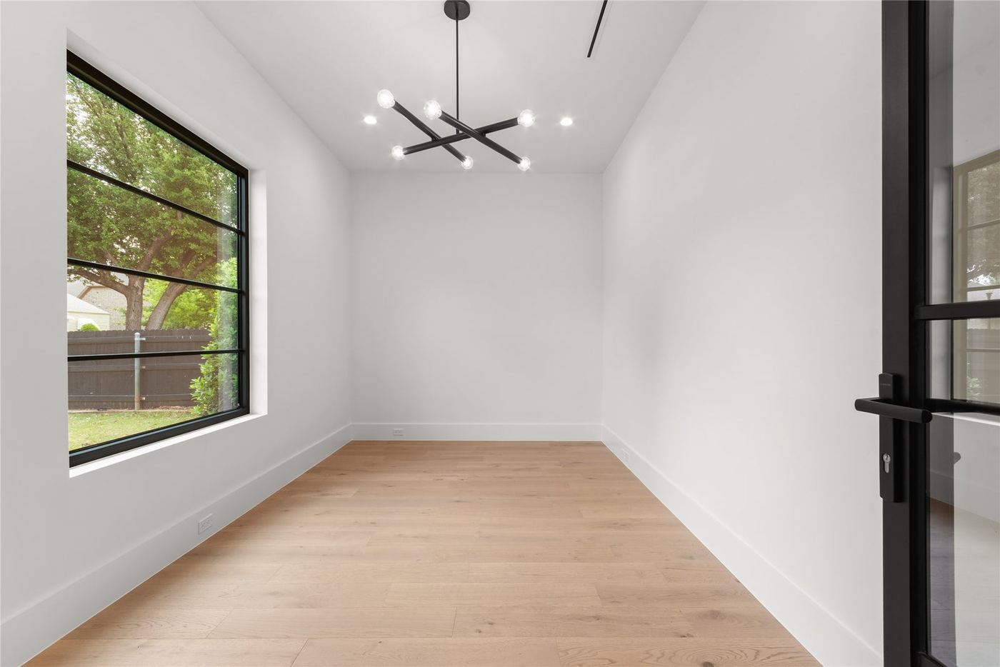 Black grid window in a white room